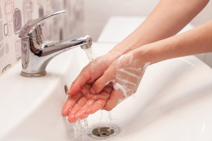 washing hands with soap at the sink