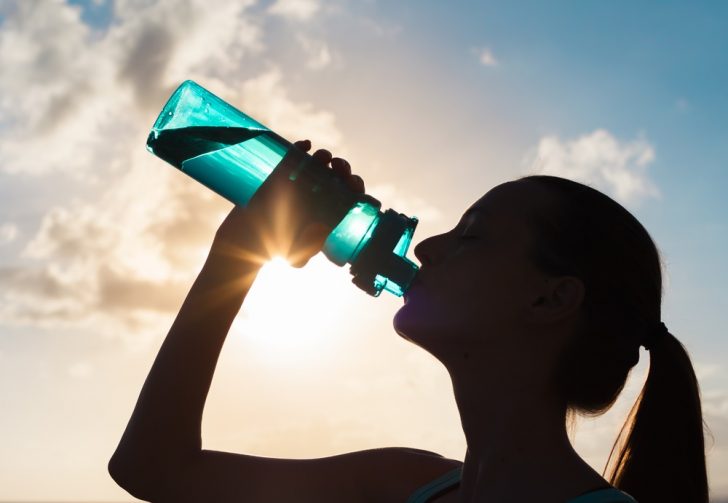 woman-drinking-water in silhouette