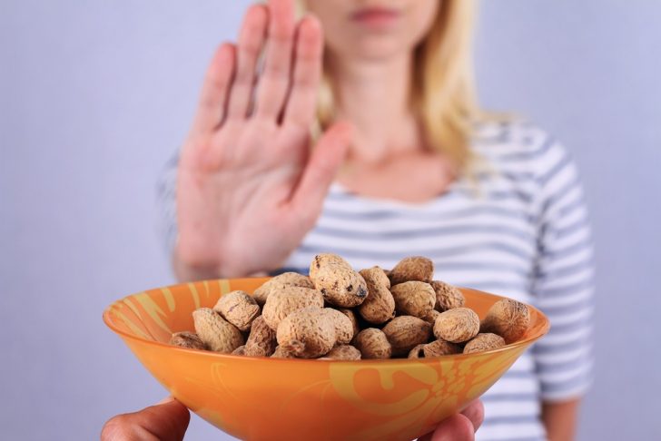 woman-with-nut-allergy refusing nuts
